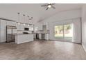 Bright and airy open-concept kitchen with stainless steel appliances and granite countertops at 22039 N 35Th Dr, Glendale, AZ 85310