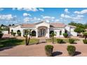 Attractive single-story home featuring beautiful masonry, arched windows, and mature palm trees at 3126 E Fruitvale Ct, Gilbert, AZ 85297