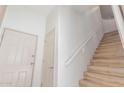 Bright hallway features a staircase with white railing and multiple entry doors for easy access at 3131 E Legacy Dr # 2113, Phoenix, AZ 85042
