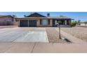 Charming single-story home featuring a two-car garage and xeriscaped front yard at 3251 W Mercer Ln, Phoenix, AZ 85029