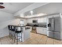 Bright kitchen featuring white cabinets, stainless steel appliances, and a breakfast bar at 3251 W Mercer Ln, Phoenix, AZ 85029