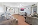 Living room featuring neutral walls, carpeting, natural light and a ceiling fan at 4122 W Las Palmaritas Dr, Phoenix, AZ 85051
