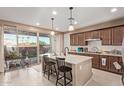 Bright kitchen featuring a center island, pendant lighting, and sliding glass doors to the backyard at 4173 E Jones St, Gilbert, AZ 85295