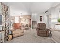 Open-concept living room with plush seating, a view into the dining area and staircase at 4173 E Jones St, Gilbert, AZ 85295