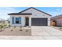 Beautiful home with a well-kept lawn, a two-car garage, and a welcoming entrance at 42510 W Peters Dr, Maricopa, AZ 85138