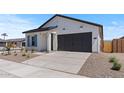 Lovely home with a two-car garage, drought-tolerant landscaping, and attractive curb appeal at 42510 W Peters Dr, Maricopa, AZ 85138