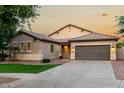 Charming single-story home featuring a neutral color palette, tile roof, and a well-manicured front lawn at 4326 E Cloudburst Ct, Gilbert, AZ 85297
