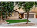 Well-maintained home boasts a tile roof, desert landscaping, and a two-car garage at 4326 E Cloudburst Ct, Gilbert, AZ 85297