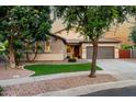 Well-maintained home boasts a tile roof, desert landscaping, and a two-car garage at 4326 E Cloudburst Ct, Gilbert, AZ 85297