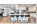 Bright, modern kitchen featuring a large island with seating, stainless steel appliances, and sleek white cabinetry at 4435 N 35Th St, Phoenix, AZ 85018