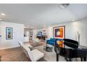 Spacious living room with modern furnishings, light walls, wood floors, and lots of natural light at 4435 N 35Th St, Phoenix, AZ 85018