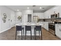 Modern kitchen features white cabinets, stainless appliances, quartz countertops, an island, and seating at 475 N 9Th St # 206, Phoenix, AZ 85006