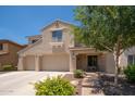 Charming two-story home with a three-car garage and inviting covered front porch at 5208 W Straight Arrow Ln, Phoenix, AZ 85083