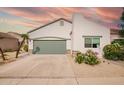 Single-Gathering home featuring desert landscaping, a two-car garage and white stucco exterior at 7031 S 32Nd Pl, Phoenix, AZ 85042