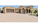 Charming home with a spacious driveway, two-car garage, and stone accents on the front columns at 7242 W Rowel Rd, Peoria, AZ 85383