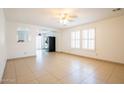Bright living room with tile, white walls, lots of windows, and an archway through to the kitchen at 8055 W Sanna St, Peoria, AZ 85345
