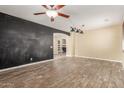 Open-concept living room featuring modern light fixtures and stylish wood-look tile flooring at 8256 W Bloomfield Rd, Peoria, AZ 85381