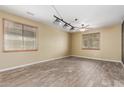 Bright living room featuring two windows, offering a relaxing atmosphere at 8256 W Bloomfield Rd, Peoria, AZ 85381