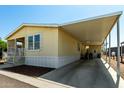 Butterscotch-colored home featuring covered parking and a clean well maintained landscape at 8832 E Pueblo Ave # 71, Mesa, AZ 85208