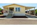 Charming, butterscotch-colored single-story home with a covered porch and convenient covered parking at 8832 E Pueblo Ave # 71, Mesa, AZ 85208