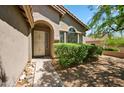 Inviting front entrance featuring a security door, decorative windows, and manicured shrubs at 10591 E Morning Star Dr, Scottsdale, AZ 85255
