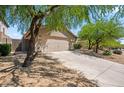 Single story home with desert landscaping, a two car garage and a long driveway at 10591 E Morning Star Dr, Scottsdale, AZ 85255