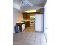Efficient kitchen with white appliances, a corner sink, and light tile flooring at 1075 E Chandler Blvd # 220, Chandler, AZ 85225