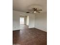Spacious living room with a ceiling fan, connecting to the backyard through a glass sliding door at 11802 N 25Th Ave, Phoenix, AZ 85029