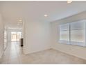 Inviting living room with tile floors, neutral walls, and access to the kitchen at 12142 E Sunflower Ln, Florence, AZ 85132