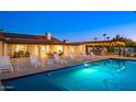 Backyard pool with several lounge chairs and an outdoor dining set near a grill area at 13620 N 80Th Pl, Scottsdale, AZ 85260