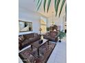 Bright living room featuring a high ceiling, comfortable seating, stylish decor, and large windows at 16242 S 12Th Pl, Phoenix, AZ 85048