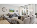 Comfortable living room with a large window, plush seating, and a wall-mounted TV for entertainment at 17850 N 68Th St # 2138, Phoenix, AZ 85054