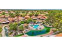 Beautiful aerial view of the community's pool and pond area with lush greenery and palm trees at 19107 N 94Th Ave, Peoria, AZ 85382