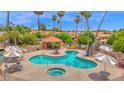 Inviting community pool and hot tub area surrounded by lush landscaping and comfortable seating at 19107 N 94Th Ave, Peoria, AZ 85382