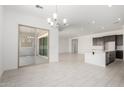 Open concept living area featuring tile floors, recessed lighting, and sliding glass doors to the patio at 20256 W Monterey Way, Buckeye, AZ 85396