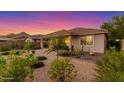 Serene backyard featuring desert landscaping, a covered patio, and a peaceful atmosphere at 20783 W Pasadena Ave, Buckeye, AZ 85396