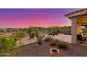 Beautiful backyard with desert landscaping, a covered patio area, and views of the surrounding mountains at 20783 W Pasadena Ave, Buckeye, AZ 85396