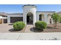 Beautiful stucco home with a turret entrance, complemented by a paved driveway and well-manicured landscaping at 22964 E Via Del Sol --, Queen Creek, AZ 85142