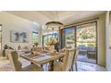 Bright dining room with table, desert landscape views, and open layout to a comfortable living area at 25555 N Windy Walk Dr # 69, Scottsdale, AZ 85255