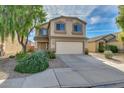 Charming two-story home with a two car garage, desert landscaping, and a cozy front porch at 3049 W Santa Cruz Ave, San Tan Valley, AZ 85144