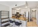 Modern kitchen featuring granite countertops, stainless steel appliances, and a breakfast bar at 3440 E Southern Ave # 1042, Mesa, AZ 85204