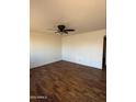 Spacious living room with beautiful wood-look flooring and ceiling fan at 3441 W Windrose Dr, Phoenix, AZ 85029