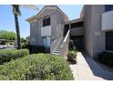 Two-story condo with stairs leading to the second level and well-maintained landscaping at 5249 E Shea Blvd # 215, Scottsdale, AZ 85254