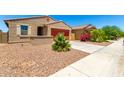 Inviting single-story home with low-maintenance desert landscaping and a neutral stucco exterior at 5626 W Rainwater Dr, Laveen, AZ 85339