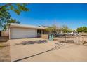 Single story house with a two car garage, fenced in yard, and a concrete driveway at 62 W Beall Ave, Mesa, AZ 85210
