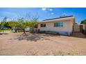 The exterior of this house features solar panels, a xeriscaped yard, and a fenced in yard at 62 W Beall Ave, Mesa, AZ 85210