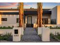 Eye-catching modern home facade with palm trees and inviting front entrance at 6303 E Via Estrella Ave, Paradise Valley, AZ 85253