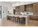Open kitchen featuring a large center island, modern cabinetry and an eating bar at 6303 E Via Estrella Ave, Paradise Valley, AZ 85253