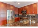 Modern kitchen featuring stainless steel appliances, granite countertops, and warm wood cabinetry at 7167 E Rancho Vista Dr # 2007, Scottsdale, AZ 85251