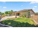 Private backyard oasis with a sparkling pool, lush lawn, and covered patio, perfect for outdoor entertaining at 8417 W Northview Ave, Glendale, AZ 85305